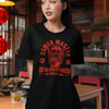 Unisex black Ramen Master graphic tee showcasing culinary delight in a cozy restaurant setting.